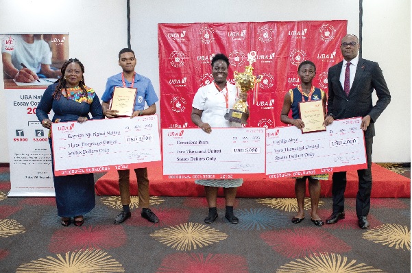 • Genevieve Budu (middle) displaying her dummy cheque and trophy. With her are Kenrich Nii Nakai Nettey (2nd from left), Cecilia Akye (2nd from right), Chris Ofikulu (right), MD, UBA, and Catherine Agyapomaa Appiah Pinkrah (left), Director in charge of General Administration at the Ministry of Education UBA rewards 2022 National Essay Competition winners