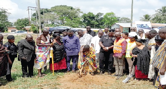 Nana Osiafo Kokroko III (with pickaxe), Poribonhene of Amanokrom, cutting the sod. Looking on are Barima Awuah Sarpong (6th from left), Edougbole Nwiah Anyimoh (5th from right), Superintendent Alhaji Abdul-Latif Nbonwura (4th from right) and queenmothers as well as staff of Ghana Gas Construction of Amanokrom police station begins