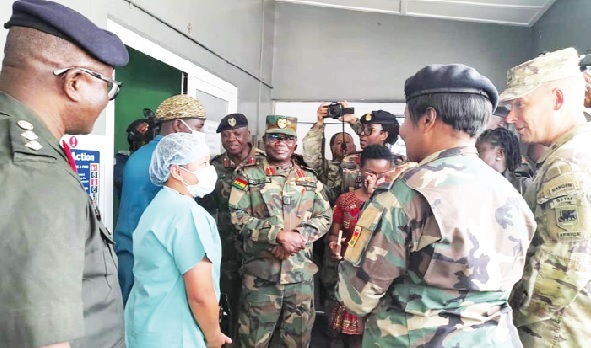 Major General Todd Wasmund (2nd from right), Commander of the US Army Southeastern Europe Task Force - Africa, interacting with a medic from the US Army Major General Todd Wasmund (2nd from right), Commander of the US Army Southeastern Europe Task Force - Africa, interacting with a medic from the US Army