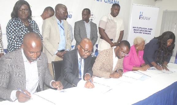 Dr Ebenezer Agbettor (2nd from left), CEO, Chartered Institute of Human Resource Managing Ghana, with Cynthia Mawulawoe Kodowu (2nd from right), CEO, HR Network and Country Manager-BTL Marketing, and some other dignitaries signing the memorandum of understanding. Picture: ESTHER ADJORKOR ADJEI