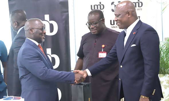 Nana Kwadwo Dwemoh Benneh (left), Chief Executive Officer, UMB, exchanging pleasantries with Ato Afful (right), MD, Graphic Communications Group Limited, after the meeting. Looking on is Theophilus Yartey, Editor, Graphic