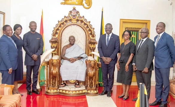 Otumfuo Osei Tutu II (seated) with executive of Prudential Bank