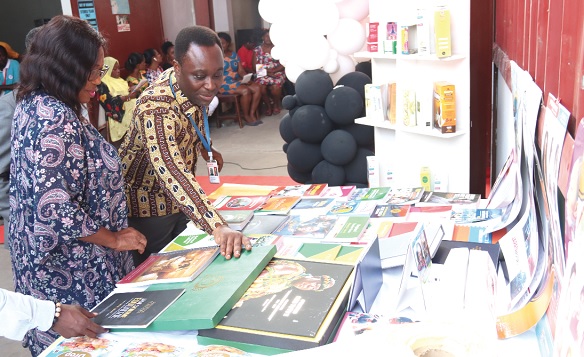 Kingsley Mate-Kole (right), General Manager, G-PAK Limited, showing Ivy Austin, Board Member, GCGL, some of the products of the company. Picture: ELVIS NII NOI DOWUONA