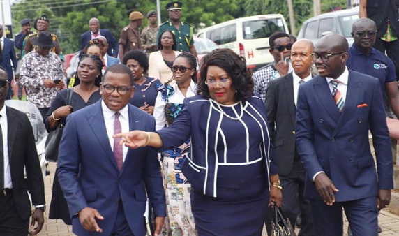 Jemima Oware (hand raised), Registrar of Companies, leading Godfred Yeboah Dame (right), Attorney-General and Minister of Justice, and some dignitaries to inspect the new office complex in Kumasi after its inauguration. Those with them include, Seth Asante (left), Chairman, Board of Directors, ORC