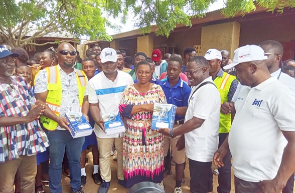 Yaw Antwi-Dadzie (2nd from right) presenting the exercise books to Madam Paulina Abem, Headmistress of Anglican JHS, while staff of the school and BOST look on. Yaw Antwi-Dadzie (2nd from right) presenting the exercise books to Madam Paulina Abem, Headmistress of Anglican JHS, while staff of the school and BOST look on.