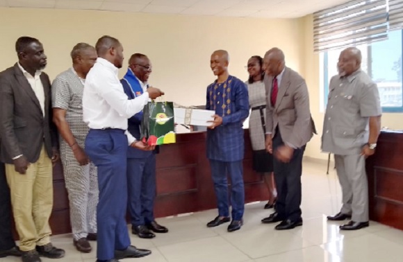 Kwasi Agyeman Busia (4th from left), CEO of DVLA, exchanging a souvenir with Prof. Martins Ekor, Provost of the College of Health and Allied Sciences of UCC. With them are officials of DVLA and UCC Kwasi Agyeman Busia (4th from left), CEO of DVLA, exchanging a souvenir with Prof. Martins Ekor, Provost of the College of Health and Allied Sciences of UCC. With them are officials of DVLA and UCC