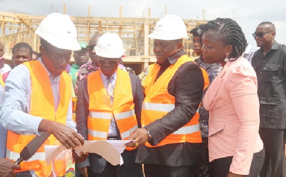 Yaw Osafo-Maafo (2nd from left), Senior Presidential Advisor; Akwasi Acquah (3rd from left), MP, and Victoria Adu (right), MCE, listening to the contractor as he briefs them on progress of the project Yaw Osafo-Maafo (2nd from left), Senior Presidential Advisor; Akwasi Acquah (3rd from left), MP, and Victoria Adu (right), MCE, listening to the contractor as he briefs them on progress of the project