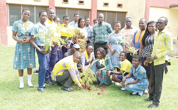 David Amevor (squatting left), the Koforidua Area Manager of ASA Savings and Loans; Elizabeth Ama Agyakwa (3rd from right), Headmistress of the Suhum Senior High Technical School, planting a seedling. Looking on are some students holding tree seedlings to also plant on the school's compound David Amevor (squatting left), the Koforidua Area Manager of ASA Savings and Loans; Elizabeth Ama Agyakwa (3rd from right), Headmistress of the Suhum Senior High Technical School, planting a seedling. Looking on are some students holding tree seedlings to also plant on the school's compound