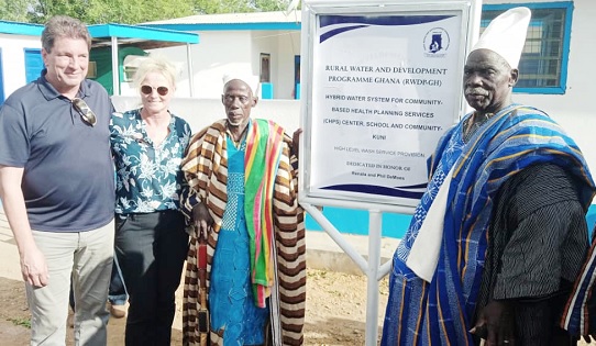 Officials of Water for West Africa being assisted by Naa Wumbei Ibrahim (middle), Chief of the Kuni community, to unveil the plaque of the facilities Officials of Water for West Africa being assisted by Naa Wumbei Ibrahim (middle), Chief of the Kuni community, to unveil the plaque of the facilities