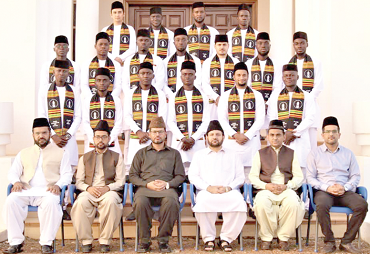 The graduates with dignitaries at the ceremony The graduates with dignitaries at the ceremony