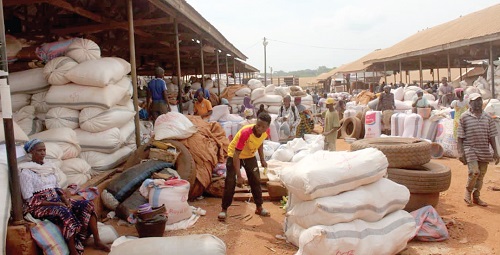 Bags of maize being packaged at the Techiman Maize Market to be transported Bags of maize being packaged at the Techiman Maize Market to be transported
