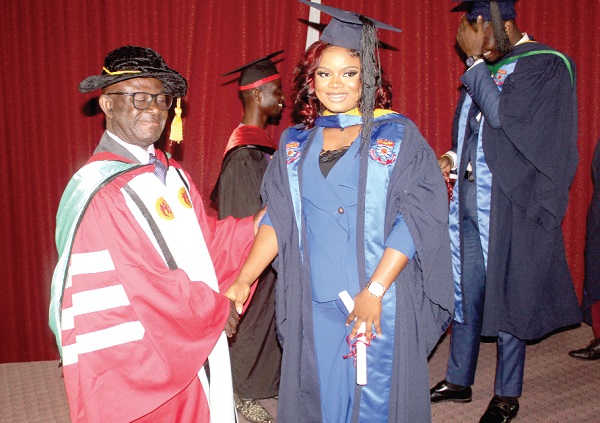 Kwame Adjei-Seffah (left), Dean of Business School, Zenith University College, congratulating Sylvia Ifeoma Anoruo, who obtained first class in Bachelor of Business Administration. Picture: ESTHER ADJORKOR ADJEI