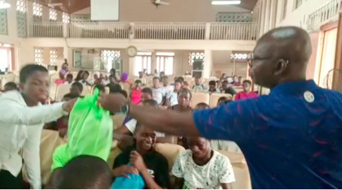 Prof. Kwasi Opoku-Amankwa handing over one of the parcels to a student Prof. Kwasi Opoku-Amankwa handing over one of the parcels to a student
