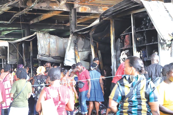 The Kejetia Market has been temporarily closed down. INSET: Some of the traders who were affected by last Wednesday night’s fire outbreak, at the Kejetia Market to count their losses Aftermath of Wednesday’s fire - Kejetia Market shut down