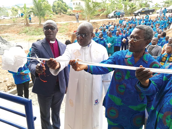 The building housing the ICT laboratory, library and other offices. INSET: Rt Rev. Professor Joseph Obiri Yeboah Mante (middle), Moderator of the General Assembly of the Presbyterian Church of Ghana, cutting the tape to officially inaugurate the building Kibi Presby College of Education marks 60th milestone