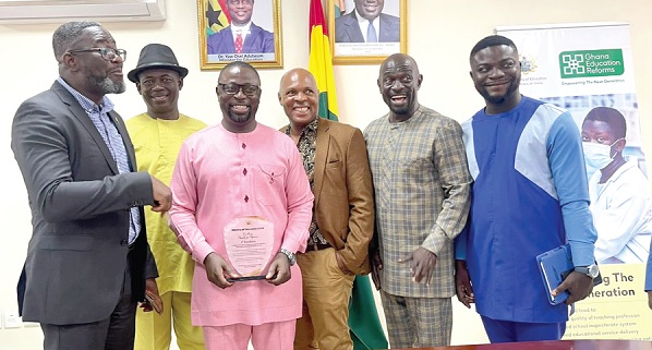 • Dr Fred Kyei Asamoah (3rd from left with the award shield), Director-General of CTVET, with some staff of the commission after receiving the award • Dr Fred Kyei Asamoah (3rd from left with the award shield), Director-General of CTVET, with some staff of the commission after receiving the award