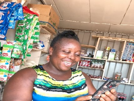 Mrs Elizabeth Amefo, a provision shop owner takes orders from her customers on WhatsApp Mrs Elizabeth Amefo, a provision shop owner takes orders from her customers on WhatsApp