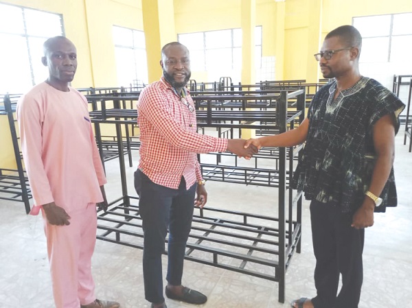 Patrick Mensah (right), Headmaster of the Odorgonno SHS, in a handshake with Ishmael Odartey Lamptey, PTA Chairman, during the presentation. With them is Samuel Fiador, Secretary of the PTA Odorgonno SHS PTA supports school with beds