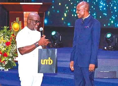 • Nana Dwemoh Benneh (left), CEO of UMB Bank, presenting a gift to Prophet Yaw Annoh, Head pastor, ICGC Holy Ghost Temple