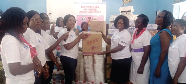 Solace A. M. Akomeah (4th from right), Secretary of WiWASH, handing over a box of sanitary pads to Mabel Adehenu (3rd from right), Head of Human Resources, Ashaiman Municipal Education Directorate. Picture: BENJAMIN XORNAM GLOVER Solace A. M. Akomeah (4th from right), Secretary of WiWASH, handing over a box of sanitary pads to Mabel Adehenu (3rd from right), Head of Human Resources, Ashaiman Municipal Education Directorate. Picture: BENJAMIN XORNAM GLOVER