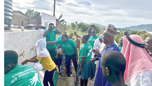Some of the beneficiaries of the community washing their hands after the commissioning Some of the beneficiaries of the community washing their hands after the commissioning