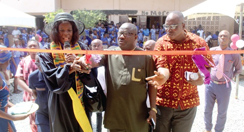 Rev. Solomon Kotey Nikoi (2nd from left), the Municipal Chief Executive of La Dade-Kotopon (LaDMA), being assisted by Rev.Vera Quaye (left), Presbyterian Church of Ghana- Nativity, and other dignitaries to inaugurate the new building block  project in the La Dade-Kotopon Municipal Assembly.  INSET:  The newly constructed block in the La Dade-Kotopon Municipal Assembly . Picture: ESTHER ADJORKOR ADJEI