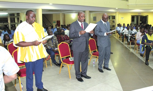 President, Ghana Academy of Arts and Sciences, inducting Prof. Joseph Awetori Yaro (left), lecturer, Geography and Resource Development, UG; Prof. Samuel Gyassi Obeng (middle), lecturer, Linguistics, UG, and Prof. Alex Boakye Asiedu (right), lecturer, Geography and Resource Development, UG, into the academy