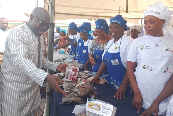Moses Anim (left), Deputy Minister of Fisheries and Aquaculture Development, interacting with some fish processors at the exhibition stand during the opening of the fish festival Moses Anim (left), Deputy Minister of Fisheries and Aquaculture Development, interacting with some fish processors at the exhibition stand during the opening of the fish festival