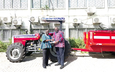 Kojo Larbi (right), Manager for Communications at Stanbic Bank Ghana, presenting documents of the tractor to Yaw Frimpong Addo, the Deputy Minister of Food and Agriculture in charge of Crops Kojo Larbi (right), Manager for Communications at Stanbic Bank Ghana, presenting documents of the tractor to Yaw Frimpong Addo, the Deputy Minister of Food and Agriculture in charge of Crops