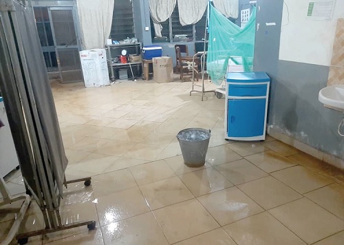 A bucket placed in one of the wards to collect rain water as it drips from the roof A bucket placed in one of the wards to collect rain water as it drips from the roof