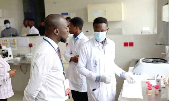 Dr Philip Adom Yeboah (left), Technical Inspector, AHPC, in a chat with a Laboratory Technician at the Ga East Municipal Hospital Dr Philip Adom Yeboah (left), Technical Inspector, AHPC, in a chat with a Laboratory Technician at the Ga East Municipal Hospital