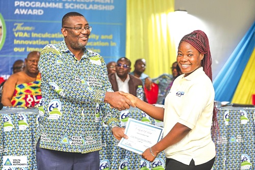 Kenneth Arthur (left), VRA Deputy Chief Executive for Services, presenting a certificate to a beneficiary Kenneth Arthur (left), VRA Deputy Chief Executive for Services, presenting a certificate to a beneficiary