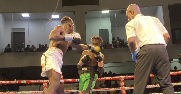Referee Roger Barnor (right) watches closely as John Laryea lands a left hook to the face of Gabriel Odoi Laryea in their clash Referee Roger Barnor (right) watches closely as John Laryea lands a left hook to the face of Gabriel Odoi Laryea in their clash