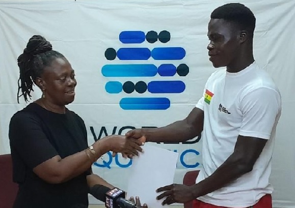 Mrs Delphina Quaye presenting the items to Christian Nii Nortey Duah Mrs Delphina Quaye presenting the items to Christian Nii Nortey Duah