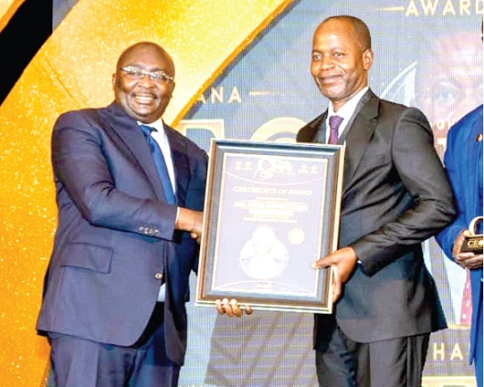  Dr Nick Danso Adjei receiving his award from Dr Mahamudu Bawumia, the Vice-President