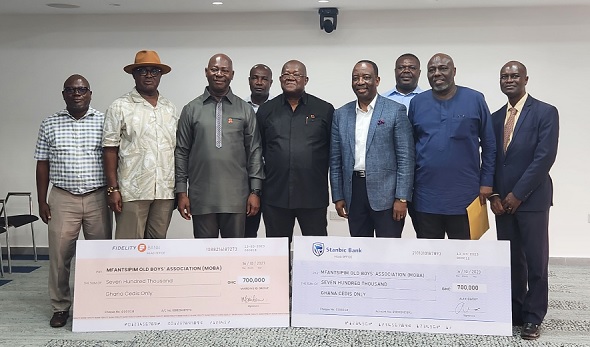 Some members of the Mfantsipim Old Boys Association with the two dummy cheques Some members of the Mfantsipim Old Boys Association with the two dummy cheques
