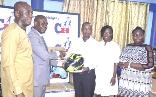 Enock Dery Pufaa (3rd from right), Programmes Director of Challenging Heights, presenting a helmet to Chief Superintendent Mike Baah (2nd from left), Head of the Anti-Human Trafficking Unit Enock Dery Pufaa (3rd from right), Programmes Director of Challenging Heights, presenting a helmet to Chief Superintendent Mike Baah (2nd from left), Head of the Anti-Human Trafficking Unit
