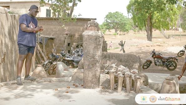 A tourist at one of the shrines during a tour