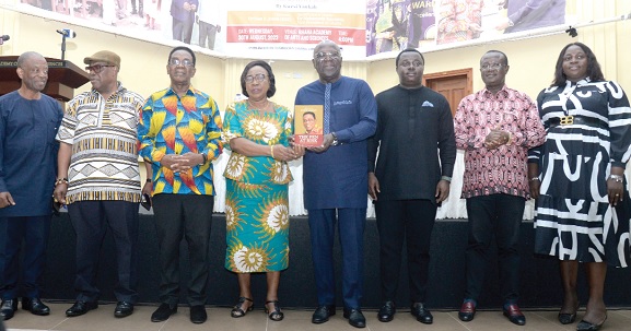 Sam Jonah (4th from right) being assisted by Victoria Yankah to launch the book. With them are Kwesi Yankah (3rd from left), Kofi Larbi (left), the publisher, and Rev. John Ntim Fordjour (3rd from right), Deputy Minister of Education; Nana Kwasi Gyan Apenteng (2nd from left)  and some other officials