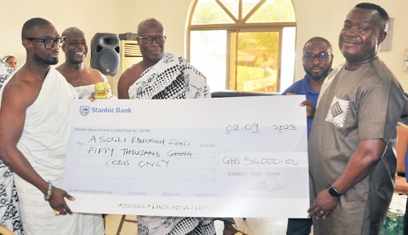 Mawuko Afadzinu (right) presenting one of the cheques to Togbe Afiatsoa III (left), Dutor of Ho, while Togbe Adu Bobi IV (middle), Afetorfia of Ho-Bankoe; Tsiami Amoaku (2nd from left) and an official of Stanbic Bank look on Mawuko Afadzinu (right) presenting one of the cheques to Togbe Afiatsoa III (left), Dutor of Ho, while Togbe Adu Bobi IV (middle), Afetorfia of Ho-Bankoe; Tsiami Amoaku (2nd from left) and an official of Stanbic Bank look on