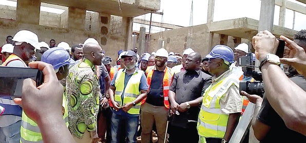 Kojo Oppong-Nkrumah (arrowed), Minister of Information, and Dr Anthony Nsiah-Asare (4th from right), Presidential Advisor on Health, being briefed on the progress of work on an Agenda 111 District Hospital at Kpassa in the Nkwanta-North District. With them is Joshua Gmayenaan Makubu (2nd from right), the Oti Regional Minister, and some workers at the project site Kojo Oppong-Nkrumah (arrowed), Minister of Information, and Dr Anthony Nsiah-Asare (4th from right), Presidential Advisor on Health, being briefed on the progress of work on an Agenda 111 District Hospital at Kpassa in the Nkwanta-North District. With them is Joshua Gmayenaan Makubu (2nd from right), the Oti Regional Minister, and some workers at the project site
