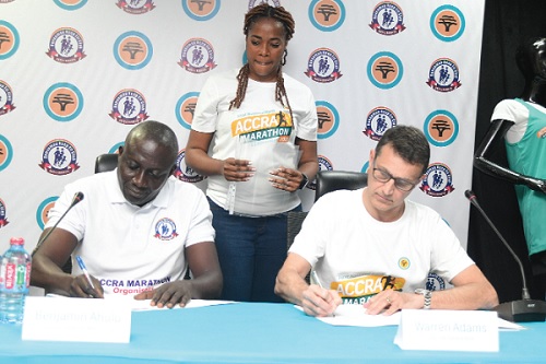 Warren Adams (right), Chief Executive Officer of the FNB, signing the agreement with Benjamin Ahulu, Chairman  of the Dansoman Keep Fit Club