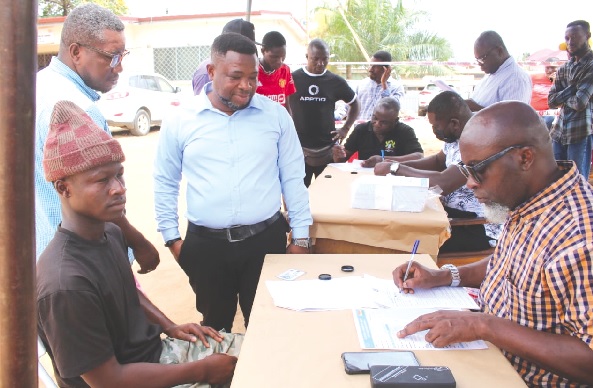 Some guarantors (standing) assisting an eligible voter (seated left) to go through the registration process. Picture: DELLA RUSSEL OCLOO Some guarantors (standing) assisting an eligible voter (seated left) to go through the registration process. Picture: DELLA RUSSEL OCLOO