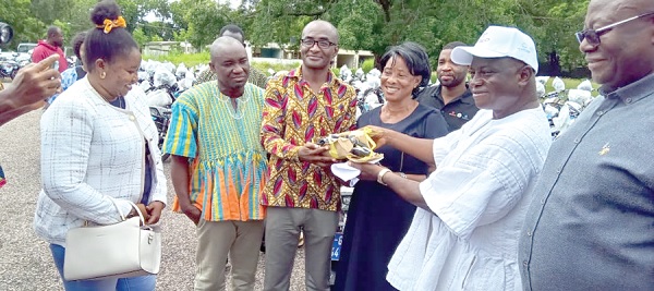Stephen Yakubu, Upper East Regional Minister (2nd from right), handing over the keys to the motorbikes to Gerard Ataogye, DCE for Kassena Nankana West, while other MDCEs look on. INSET: The motorbikes Stephen Yakubu, Upper East Regional Minister (2nd from right), handing over the keys to the motorbikes to Gerard Ataogye, DCE for Kassena Nankana West, while other MDCEs look on. INSET: The motorbikes