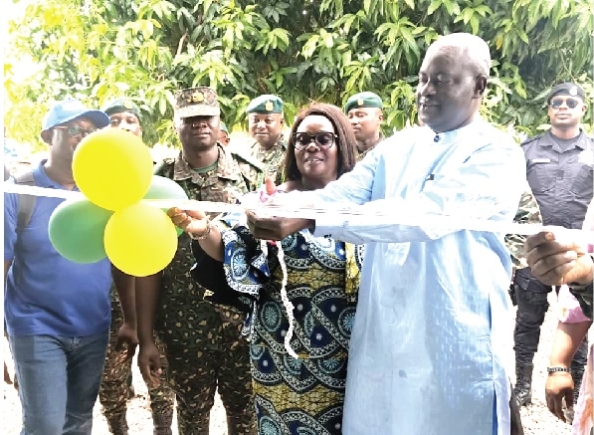 Naana Eyiah (middle), Deputy Minister for the Interior, being assisted by Dr Hafiz Bin Salih, Upper East Regional Minister, to cut the tape to commission the border post Naana Eyiah (middle), Deputy Minister for the Interior, being assisted by Dr Hafiz Bin Salih, Upper East Regional Minister, to cut the tape to commission the border post