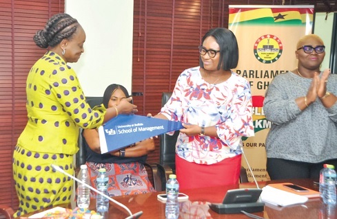 Dr Dorothy Siaw-Asamoah (left) receiving a gift from Effia Tenge, Director, Public Engagement of Parliament, on behalf of the Parliamentary Service Board Dr Dorothy Siaw-Asamoah (left) receiving a gift from Effia Tenge, Director, Public Engagement of Parliament, on behalf of the Parliamentary Service Board