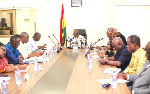 Ken Ofori-Atta (head of table), Minister of Finance, addressing participants in the press conference Ken Ofori-Atta (head of table), Minister of Finance, addressing participants in the press conference