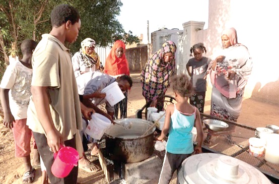 Displaced Sudanese families waiting to receive food from a charity kitchen, as a year of war between two generals has driven more than 5.8 million people into poverty Displaced Sudanese families waiting to receive food from a charity kitchen, as a year of war between two generals has driven more than 5.8 million people into poverty