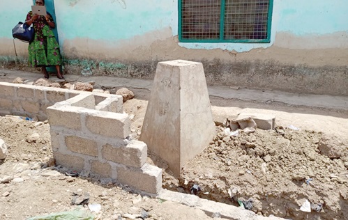 One of the boundary pillars being destroyed by a private developer
