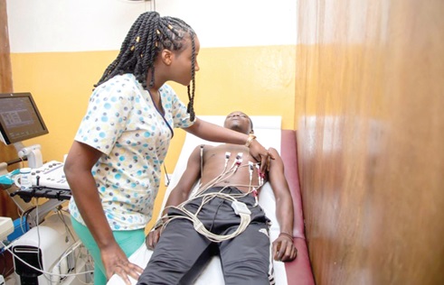A cardiac nurse at Yaaba Medical Services performing an electrocardiogram test on a patient A cardiac nurse at Yaaba Medical Services performing an electrocardiogram test on a patient